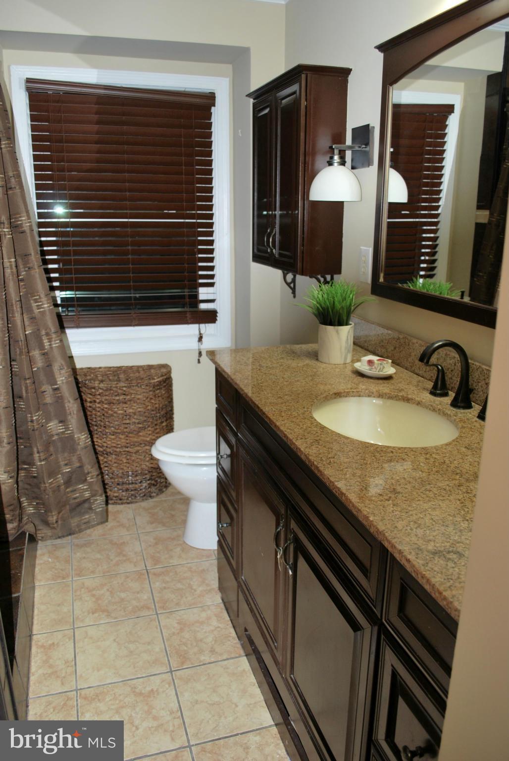 9304 Fort Foote Road Fort Washington, MD 20744 - Photo 15 of 30 Hall bath has custom tile and rain shower head