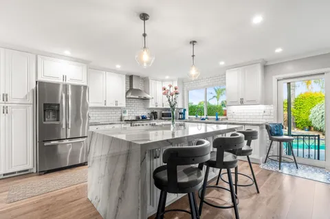 a view of a house with backyard and sitting area