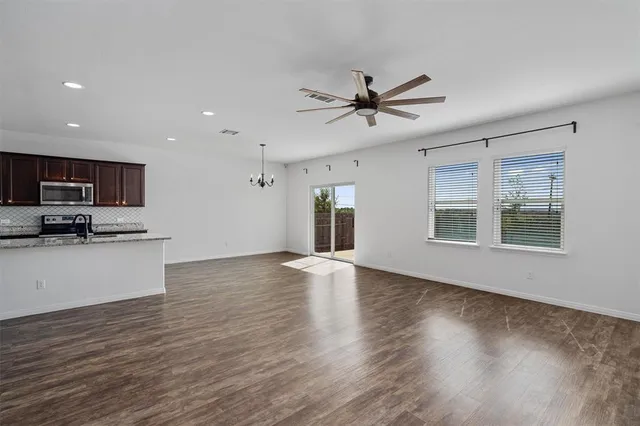 an empty room with wooden floor and door
