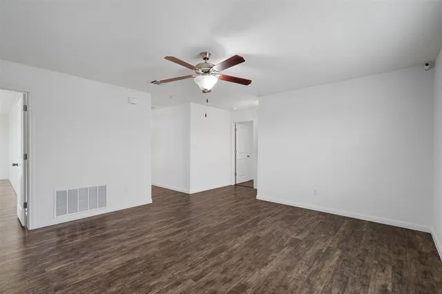 a bathroom with a granite countertop sink a toilet and a mirror