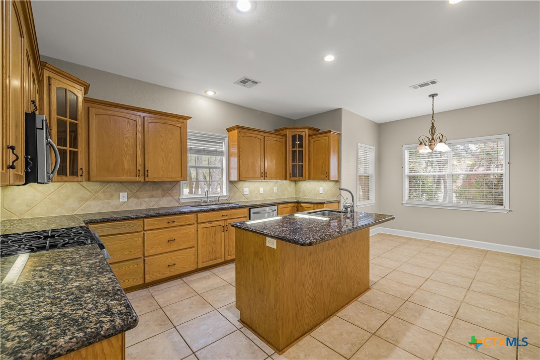 233 Post Oak Bend Inez, TX 77968 - Photo 11 of 45 a kitchen with stainless steel appliances granite countertop a stove a sink and a microwave