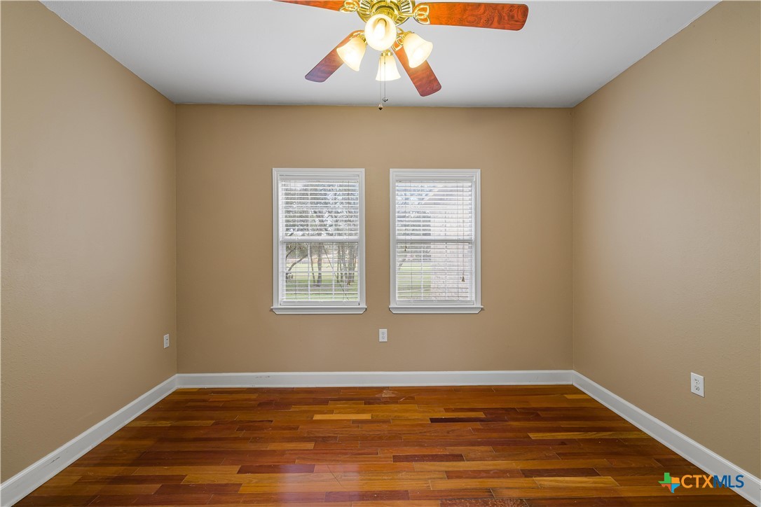 233 Post Oak Bend Inez, TX 77968 - Photo 20 of 45 an empty room with wooden floor and windows