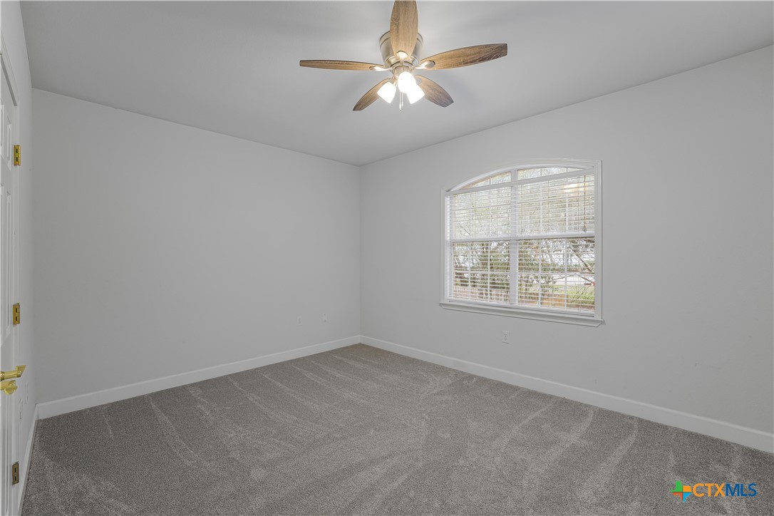 233 Post Oak Bend Inez, TX 77968 - Photo 23 of 45 an empty room with a window and a fan