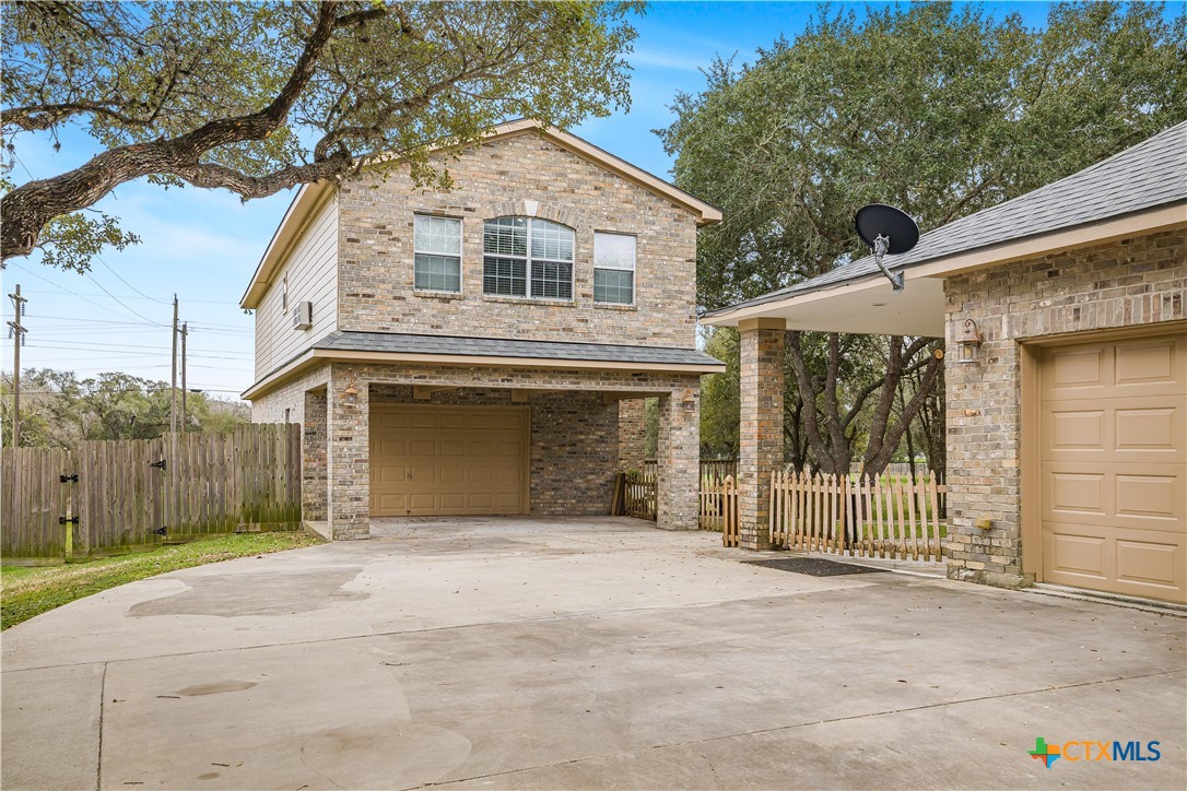 233 Post Oak Bend Inez, TX 77968 - Photo 9 of 45 a front view of a house with a garage