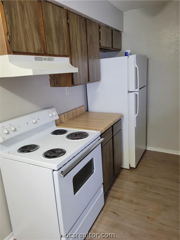 2712 Evergreen Circle Bryan, TX 77801 - Photo 4 of 30 Kitchen with light wood-type flooring and white appliances