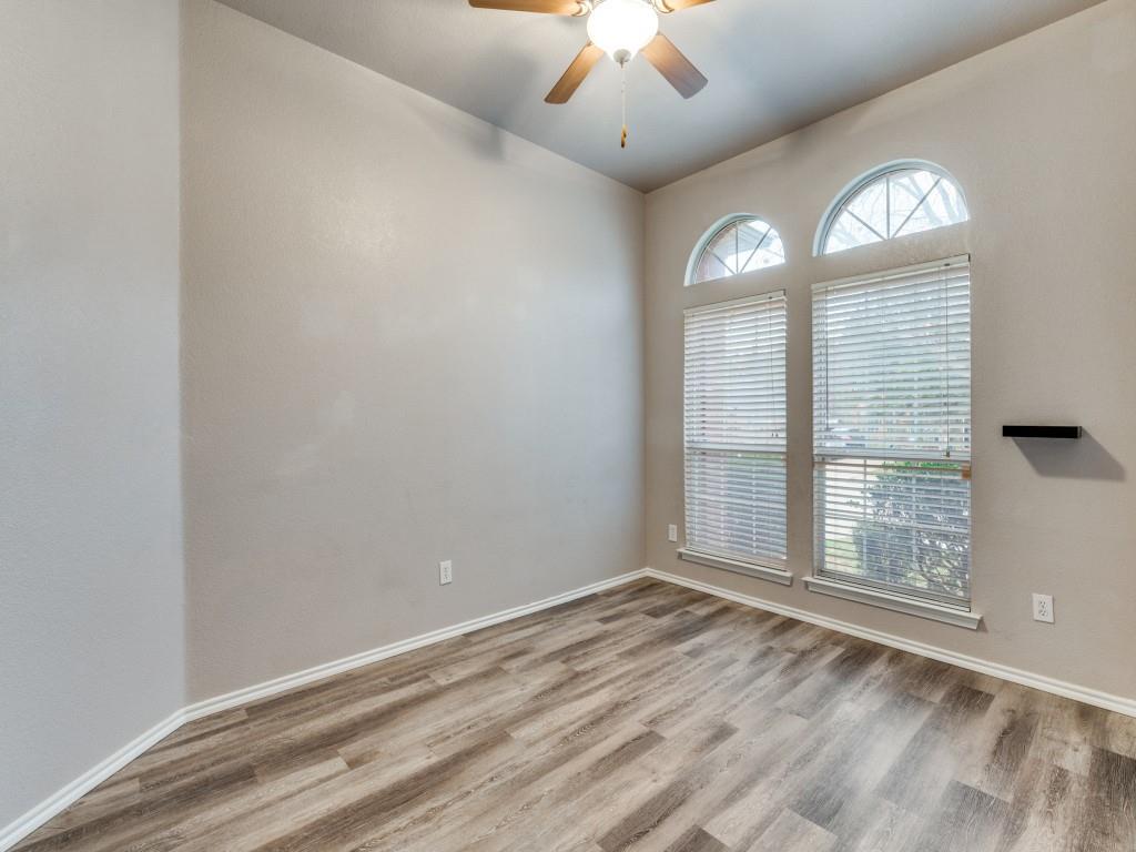 2939 Alyson Way Grand Prairie, TX 75052 - Photo 16 of 20 an empty room with wooden floor fan and windows