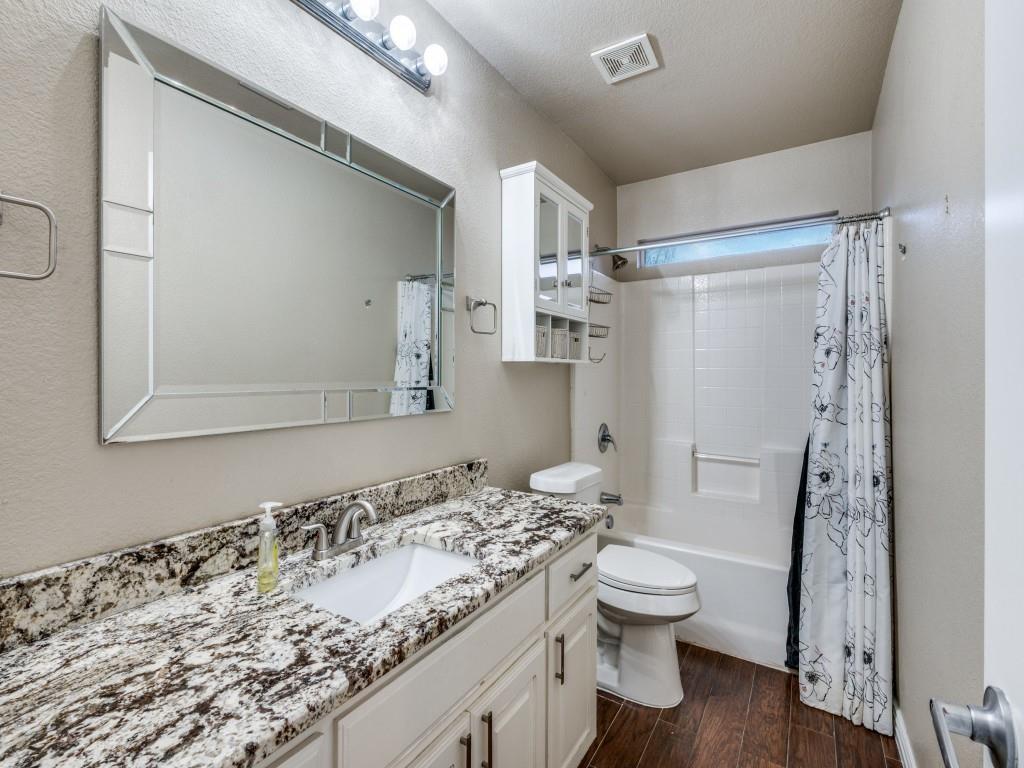 2939 Alyson Way Grand Prairie, TX 75052 - Photo 6 of 20 a bathroom with a granite countertop sink toilet and shower