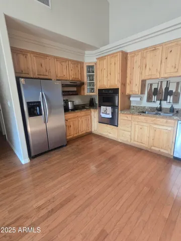 a kitchen with stainless steel appliances granite countertop a refrigerator a stove a sink and a microwave