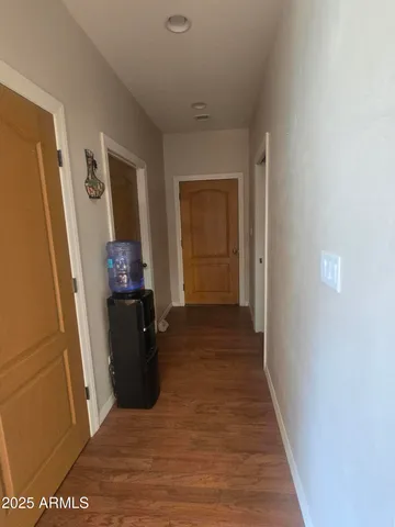 a view of a hallway to a livingroom with furniture