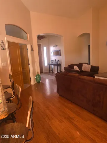 a living room with furniture and a wooden floor