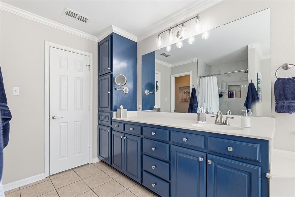 105 Cheyenne Trail Gilmer, TX 75644 - Photo 11 of 35 a bathroom with a double vanity sink and a mirror