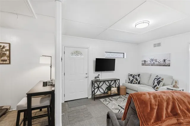 a living room with furniture and a flat screen tv