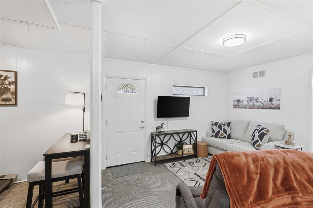 105 Cheyenne Trail Gilmer, TX 75644 - Photo 19 of 35 a living room with furniture and a flat screen tv