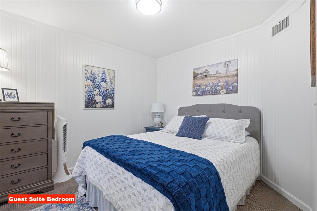 105 Cheyenne Trail Gilmer, TX 75644 - Photo 20 of 35 a bedroom with a bed and a painting on the wall