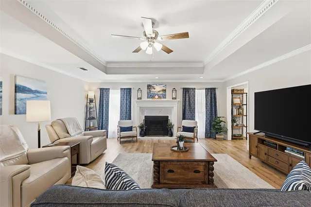 a living room with furniture a fireplace and a flat screen tv