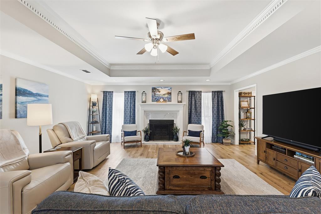 105 Cheyenne Trail Gilmer, TX 75644 - Photo 2 of 35 a living room with furniture a fireplace and a flat screen tv