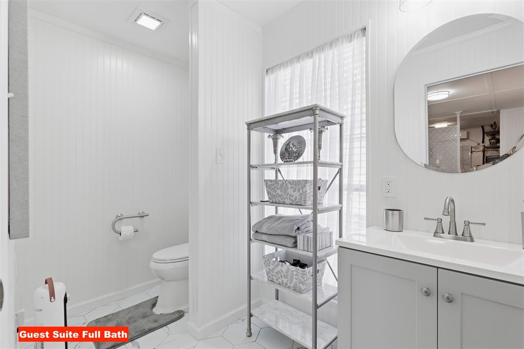 105 Cheyenne Trail Gilmer, TX 75644 - Photo 23 of 35 a bathroom with a toilet a sink and a mirror