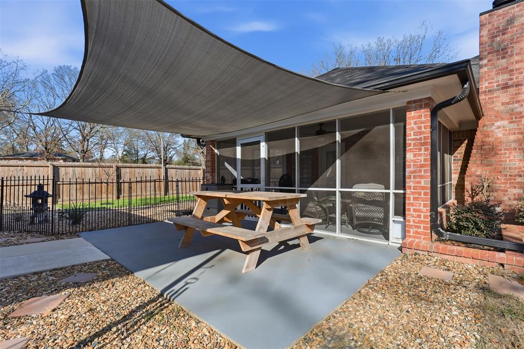 105 Cheyenne Trail Gilmer, TX 75644 - Photo 29 of 35 a backyard of a house with barbeque oven table and chairs