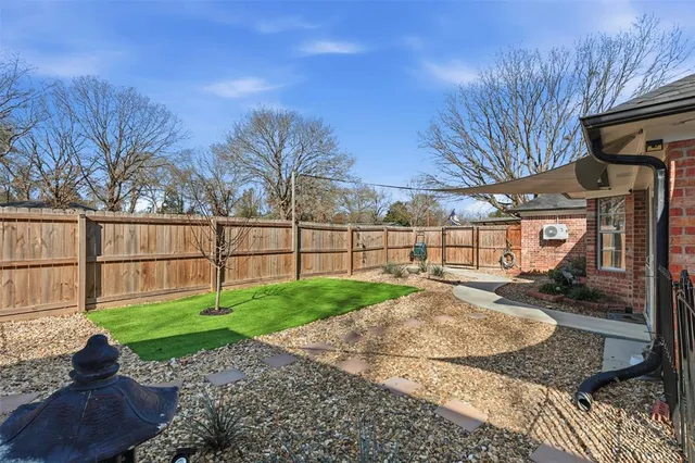 a view of a backyard with large trees