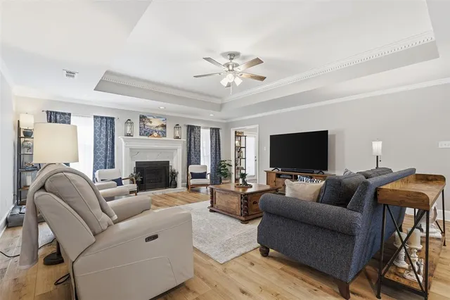 a living room with furniture a flat screen tv and a fireplace