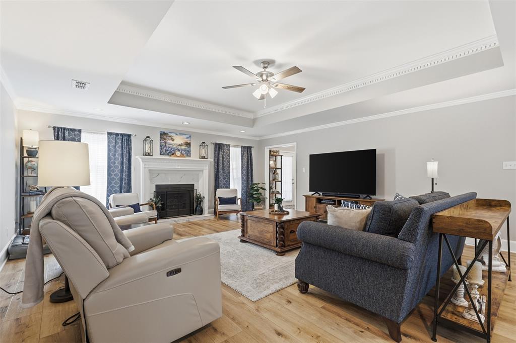 105 Cheyenne Trail Gilmer, TX 75644 - Photo 3 of 35 a living room with furniture a flat screen tv and a fireplace