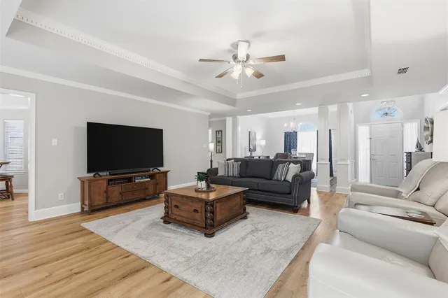 a living room with furniture and a flat screen tv