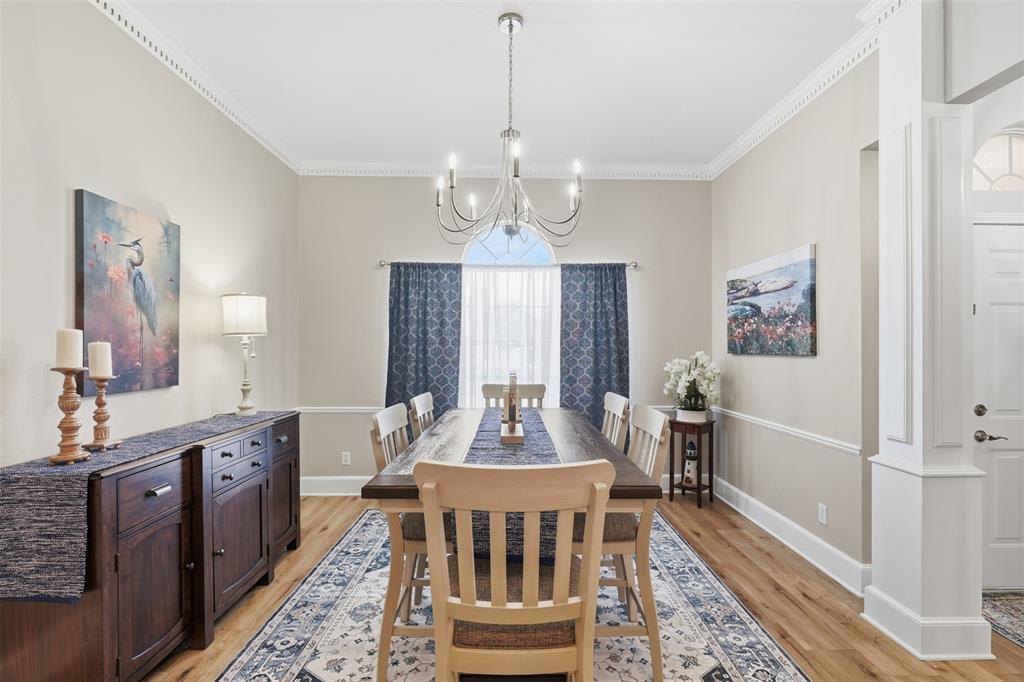 105 Cheyenne Trail Gilmer, TX 75644 - Photo 6 of 35 a dining room with wooden floor a chandelier a wooden table and chairs