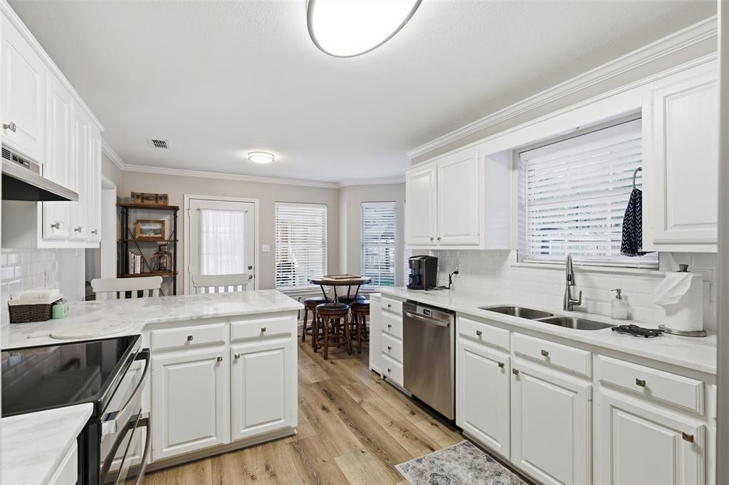 105 Cheyenne Trail Gilmer, TX 75644 - Photo 7 of 35 a kitchen with a sink stove cabinets and wooden floor