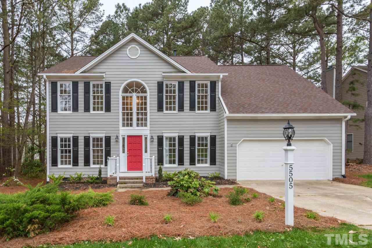 5505 Raddington Street Raleigh, NC 27613 - Photo 1 of 25 a front view of a house with a yard and garage