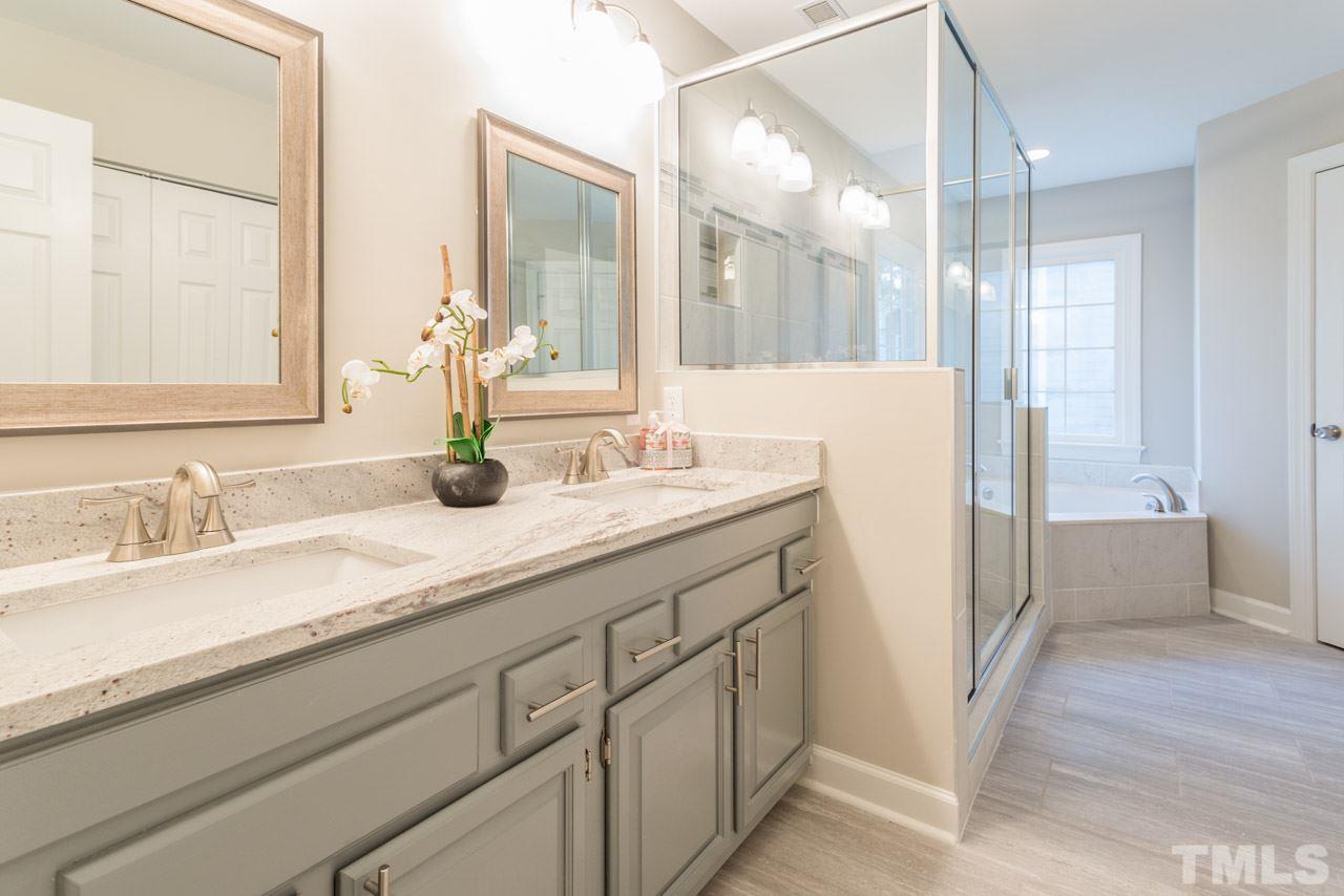 5505 Raddington Street Raleigh, NC 27613 - Photo 12 of 25 a bathroom with a sink and a mirror