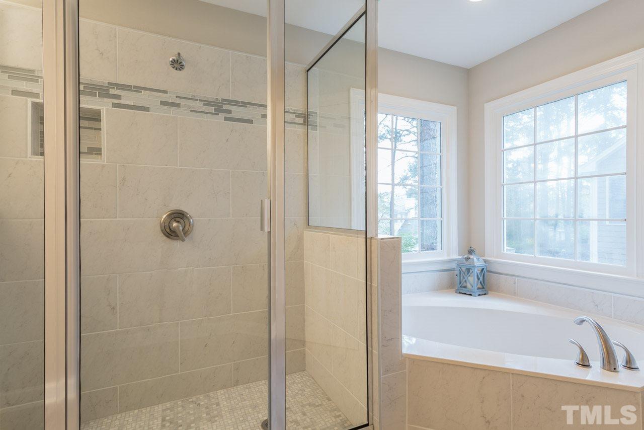 5505 Raddington Street Raleigh, NC 27613 - Photo 13 of 25 a bathroom with a bathtub and a shower