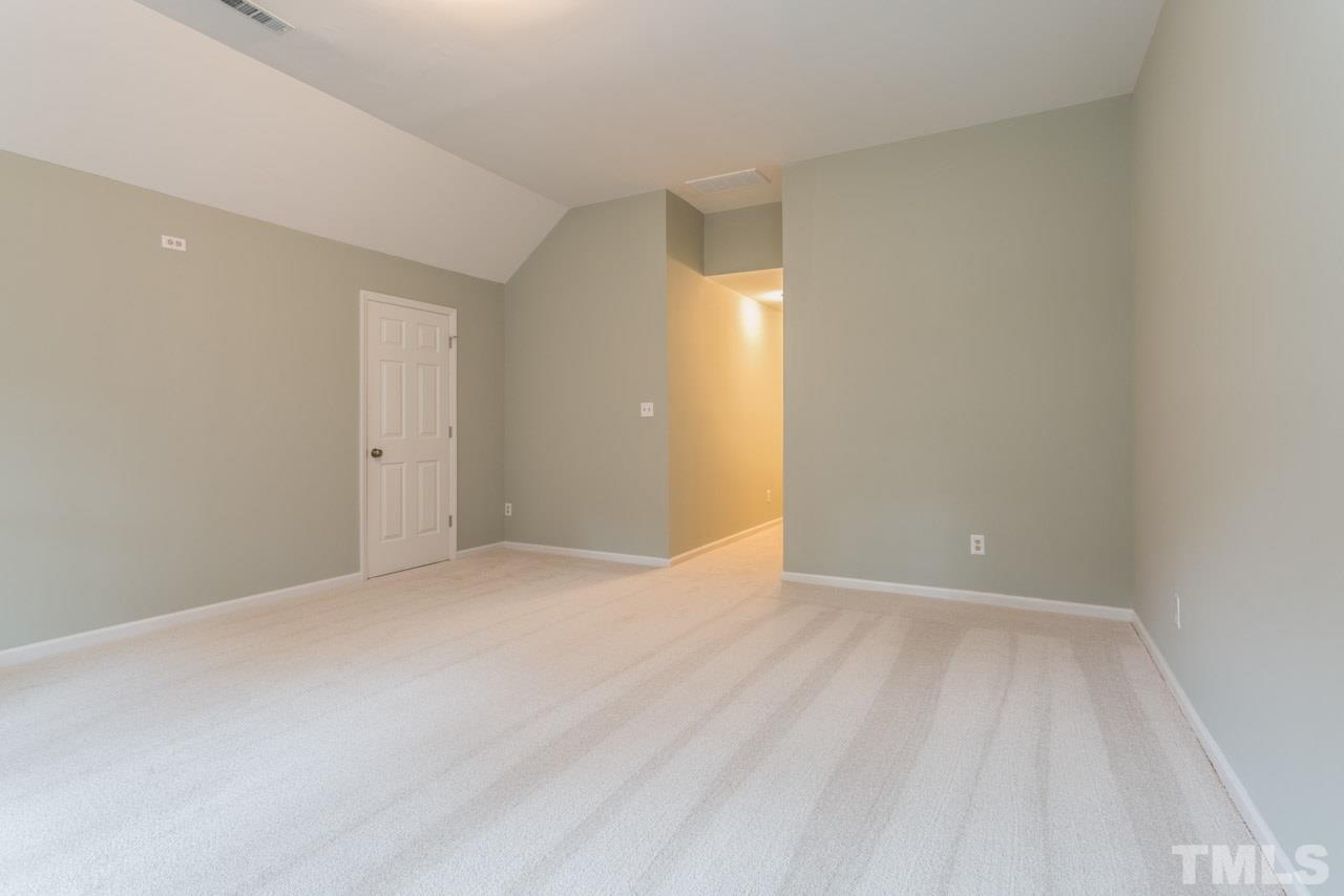 5505 Raddington Street Raleigh, NC 27613 - Photo 18 of 25 a view of an empty room with wooden floor