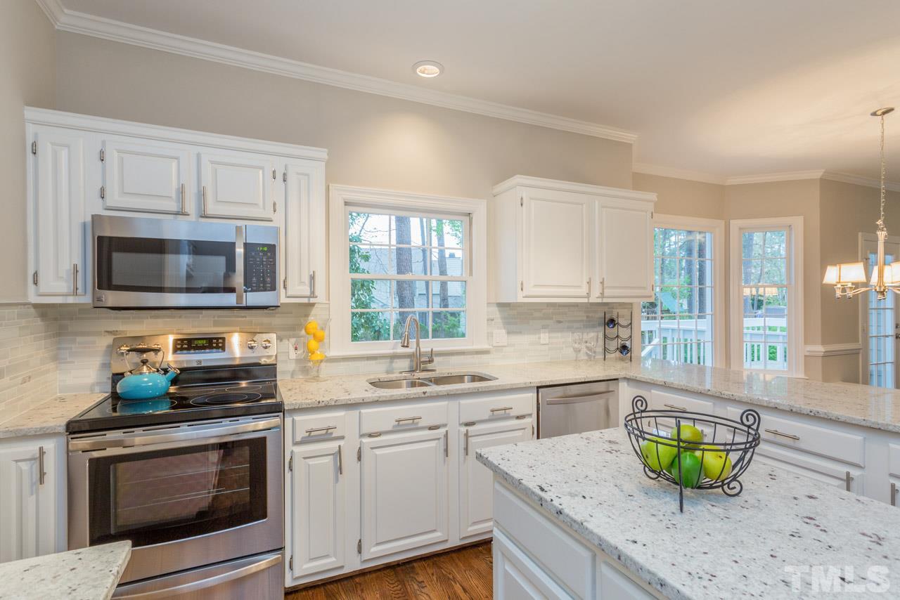 5505 Raddington Street Raleigh, NC 27613 - Photo 3 of 25 a kitchen with a stove a sink and a microwave