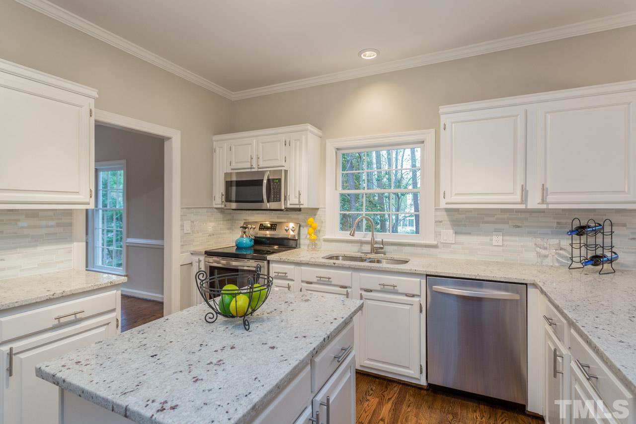 5505 Raddington Street Raleigh, NC 27613 - Photo 4 of 25 a kitchen with a sink a counter top space and appliances