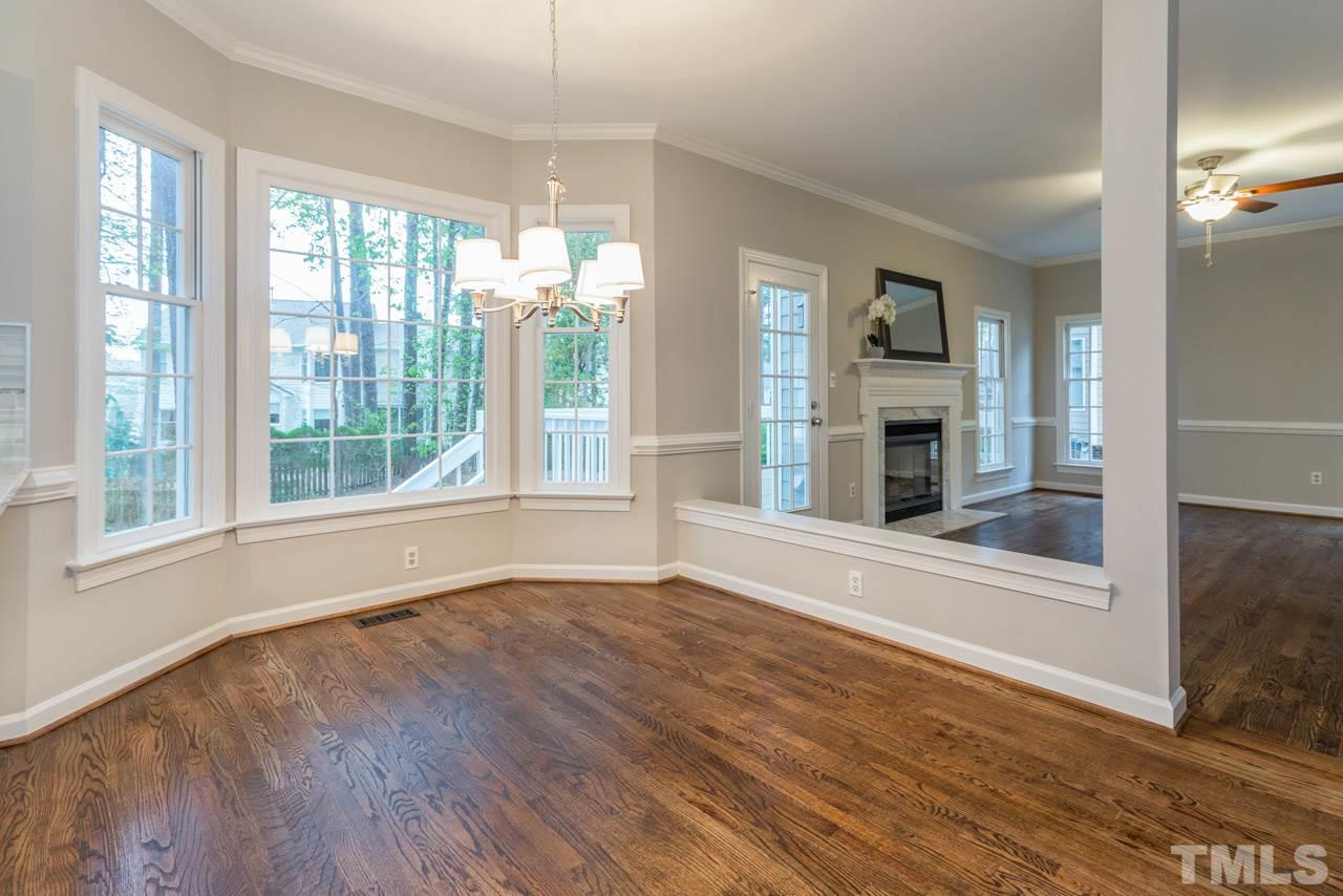 5505 Raddington Street Raleigh, NC 27613 - Photo 7 of 25 a view of an empty room with a window and wooden floor