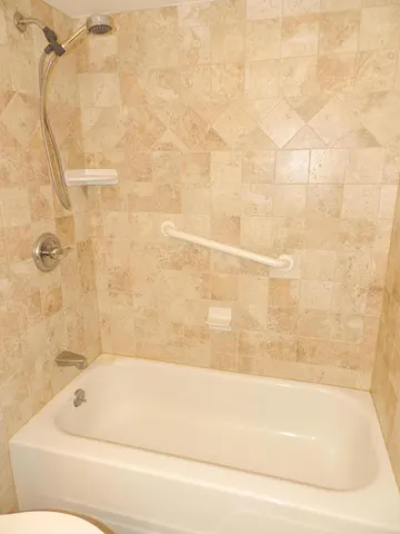 a bathroom with a bathtub and shower