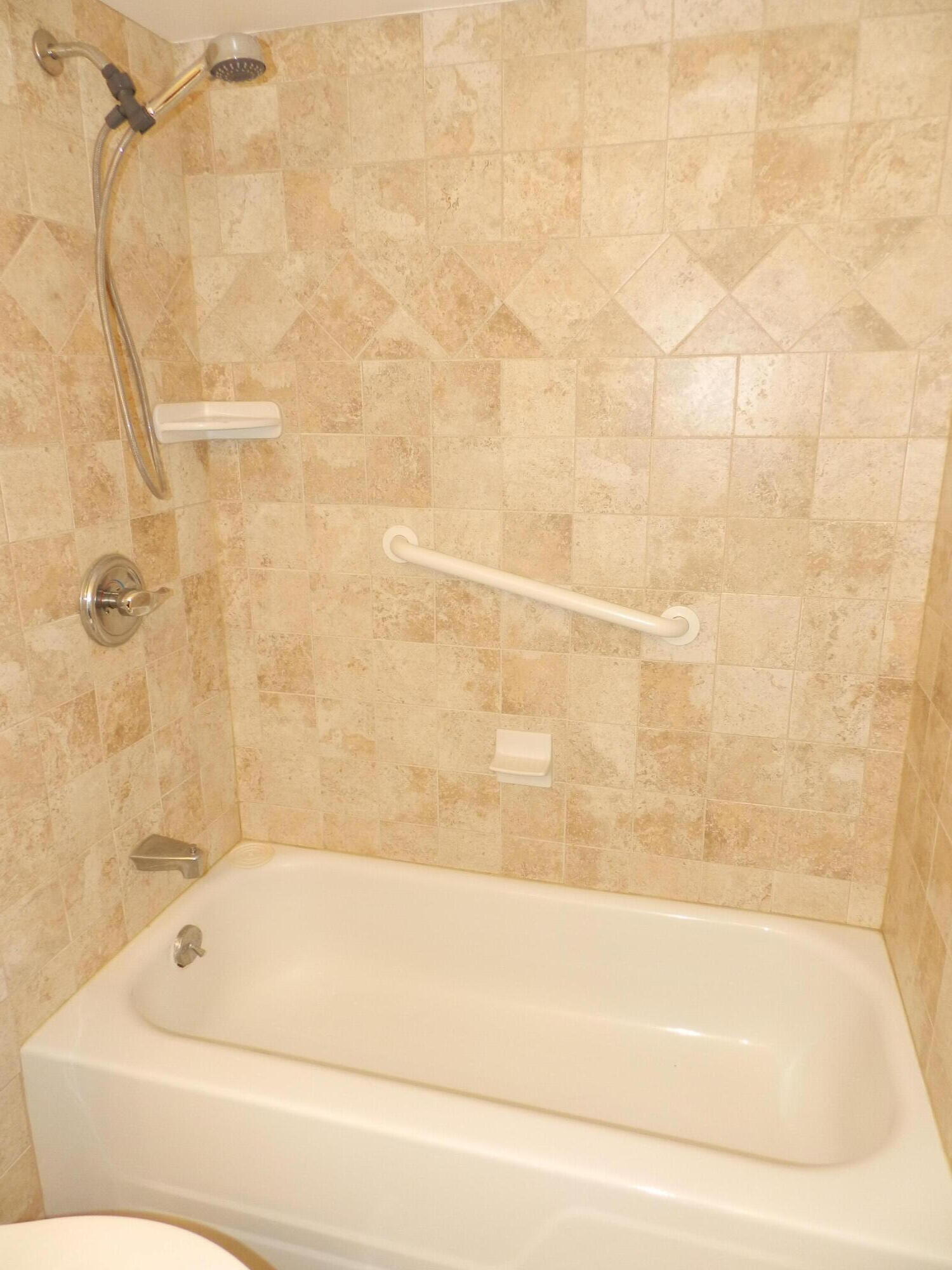 3 Greenway Village North, Unit 108 Royal Palm Beach, FL 33411 - Photo 14 of 29 a bathroom with a bathtub and shower