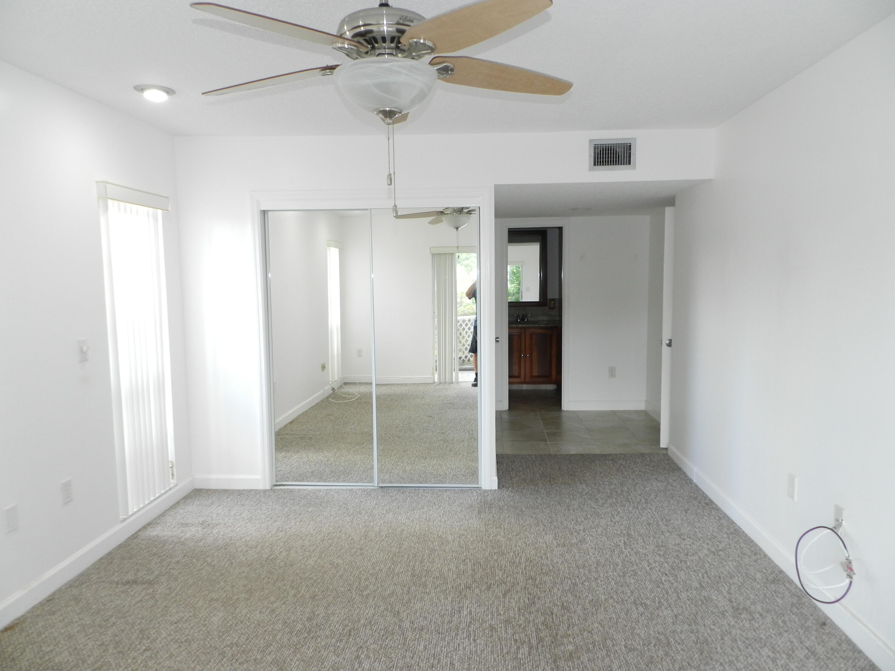 3 Greenway Village North, Unit 108 Royal Palm Beach, FL 33411 - Photo 18 of 29 a view of an empty room and a ceiling fan