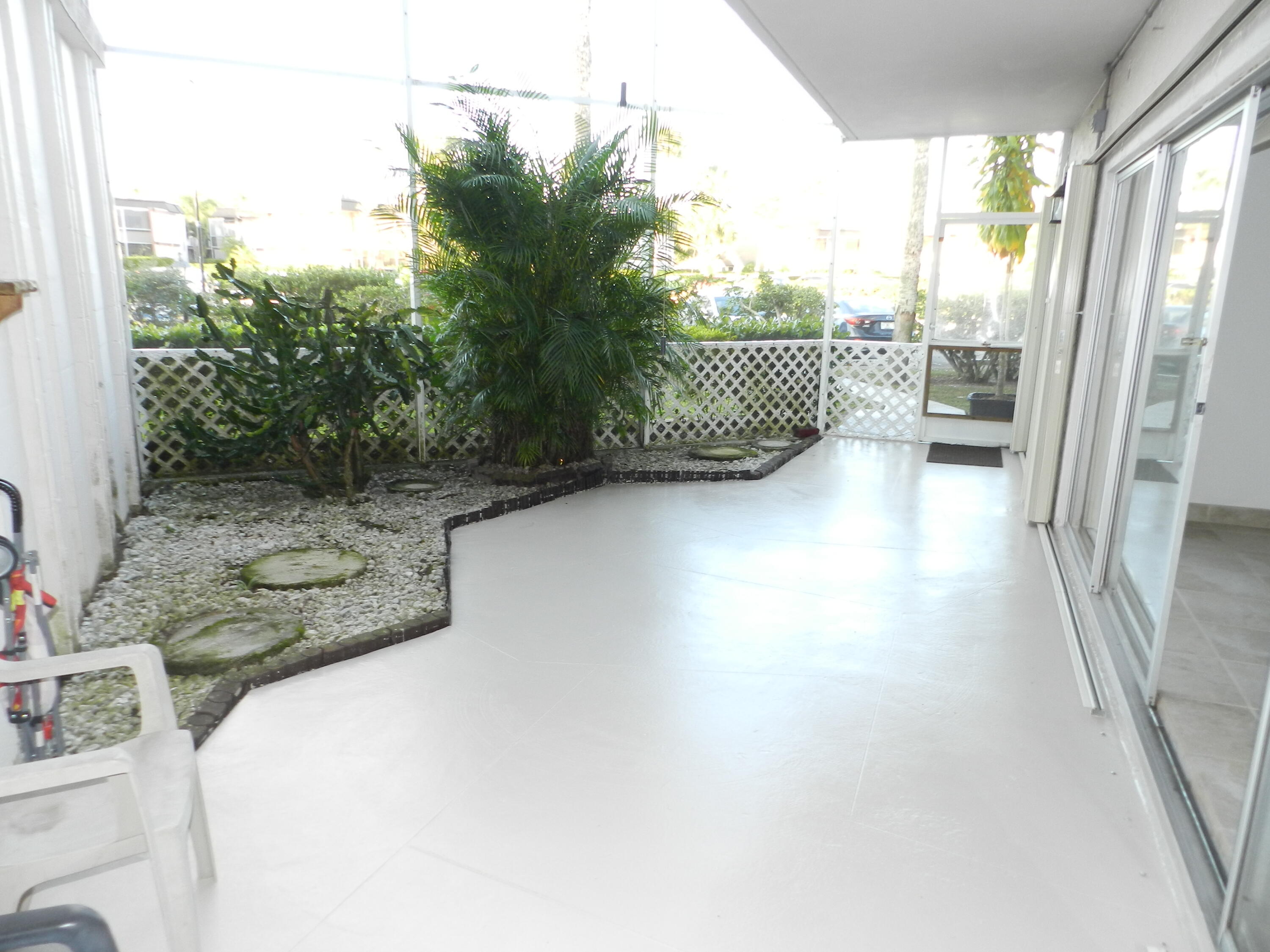 3 Greenway Village North, Unit 108 Royal Palm Beach, FL 33411 - Photo 29 of 29 a view of a porch with furniture and floor to ceiling window