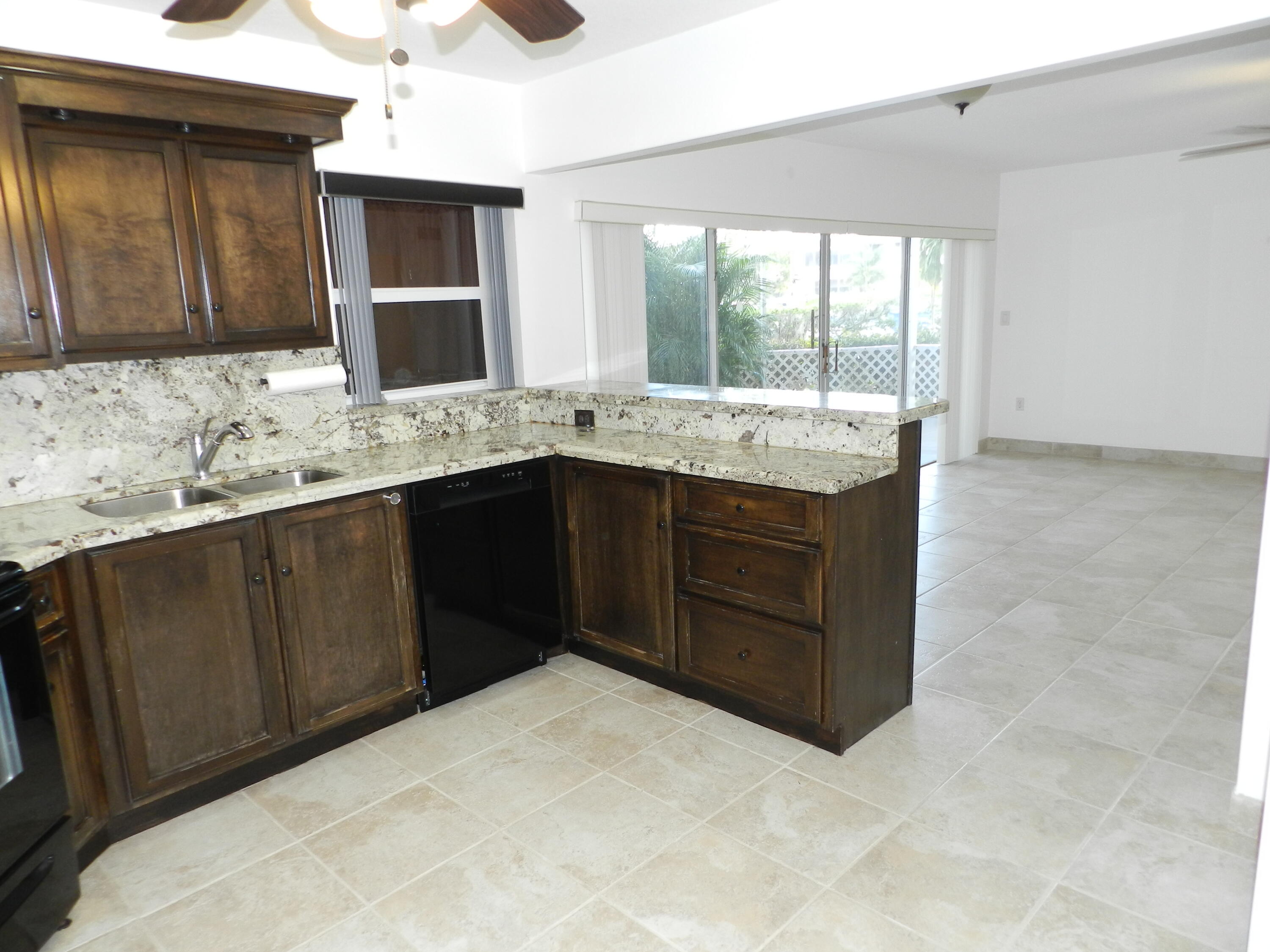 3 Greenway Village North, Unit 108 Royal Palm Beach, FL 33411 - Photo 5 of 29 a kitchen with a sink and cabinets