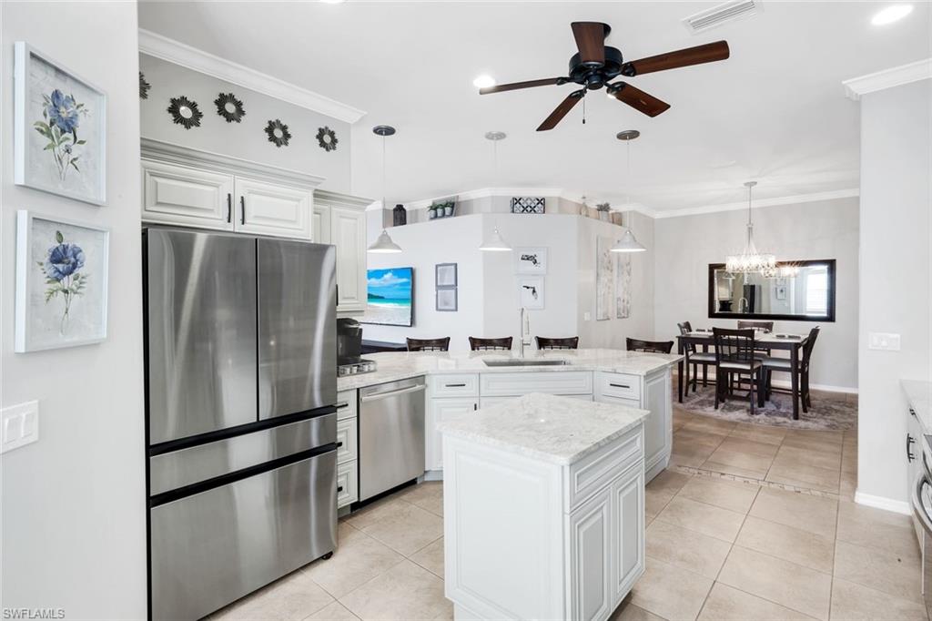 12694 Fox Ridge Drive Bonita Springs, FL 34135 - Photo 11 of 35 a kitchen with stainless steel appliances a refrigerator sink and stove