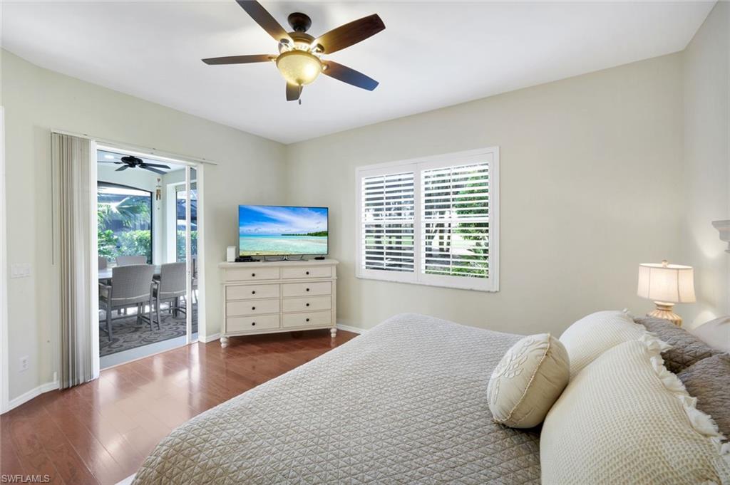 12694 Fox Ridge Drive Bonita Springs, FL 34135 - Photo 17 of 35 a bedroom with a bed and wooden floor