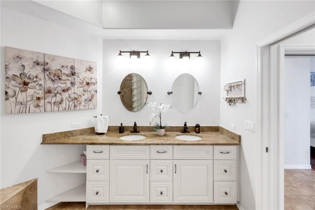 12694 Fox Ridge Drive Bonita Springs, FL 34135 - Photo 19 of 35 a bathroom with a granite countertop sink mirror and vanity
