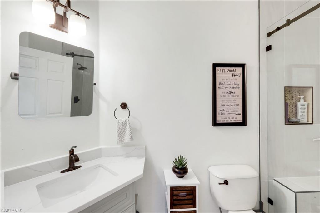 12694 Fox Ridge Drive Bonita Springs, FL 34135 - Photo 22 of 35 a bathroom with a sink toilet and mirror