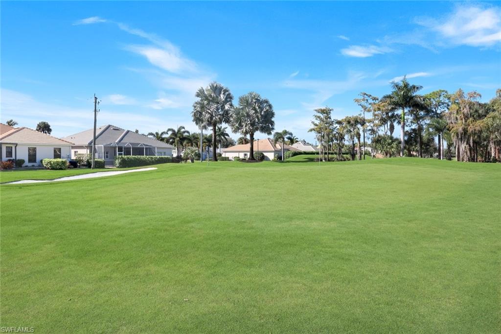 12694 Fox Ridge Drive Bonita Springs, FL 34135 - Photo 32 of 35 a view of a field of grass and trees