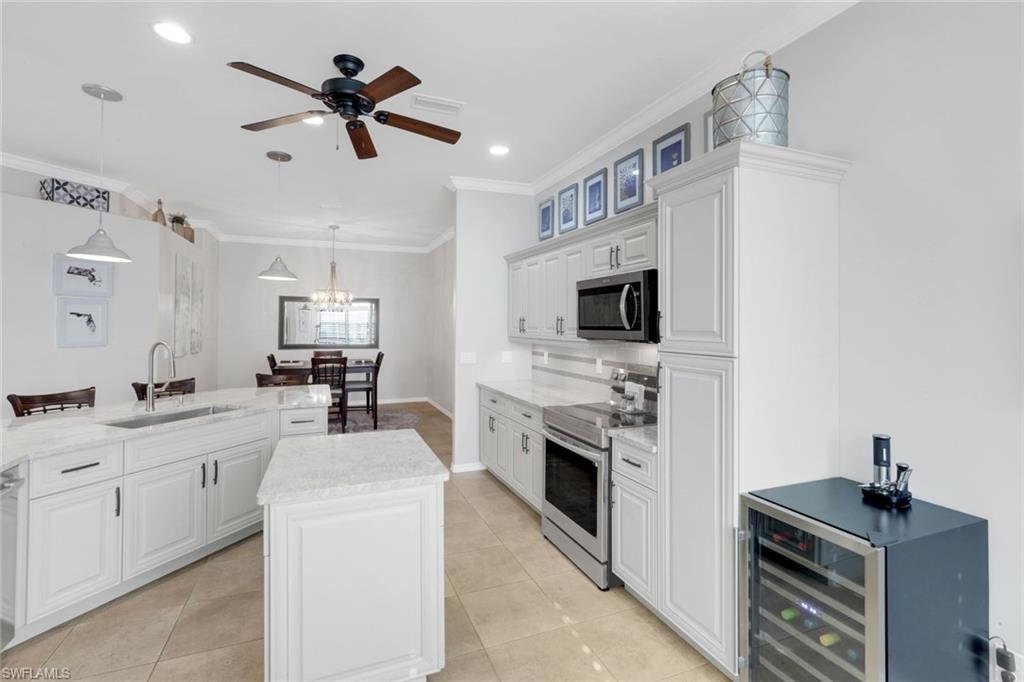 12694 Fox Ridge Drive Bonita Springs, FL 34135 - Photo 8 of 35 a kitchen with a sink stove and microwave