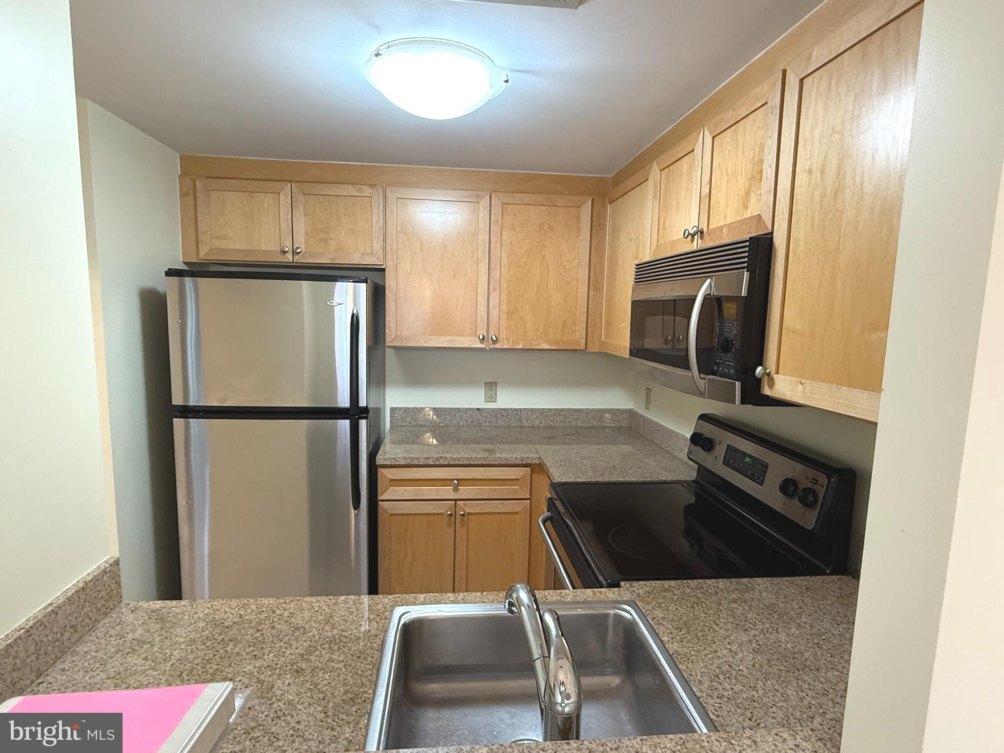 1150 K Street Northwest, Unit 506 Washington, DC 20005 - Photo 4 of 14 a kitchen with a refrigerator sink and microwave
