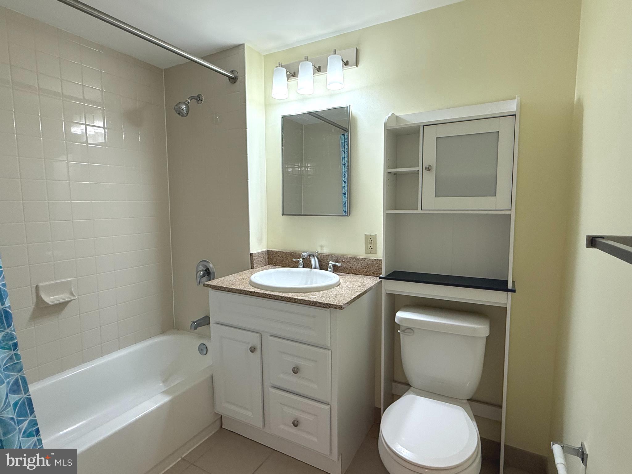 1150 K Street Northwest, Unit 506 Washington, DC 20005 - Photo 8 of 14 a bathroom with a granite countertop sink toilet and shower