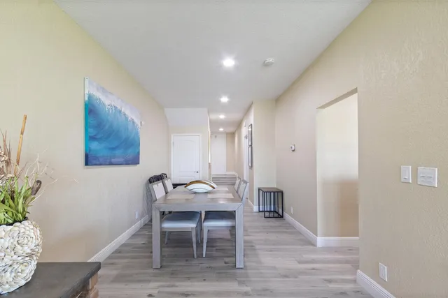 a dining room with furniture and wooden floor
