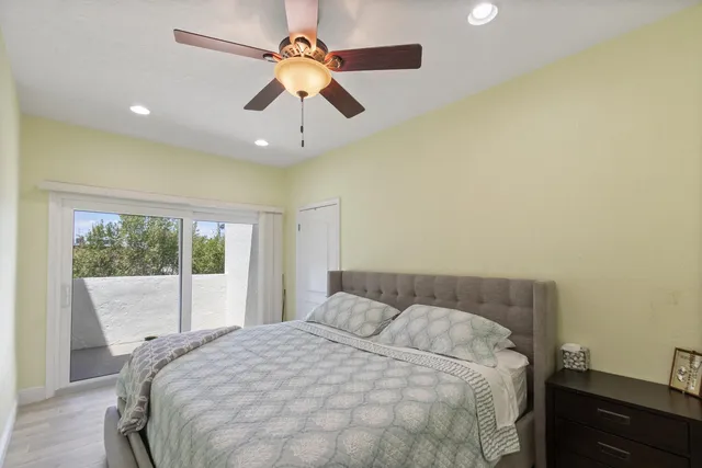 a bedroom with a large bed and a large window